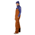 Side view of the Rossignol Outerlimits Insulated Bib in DEEP CARAMEL colourway, women model