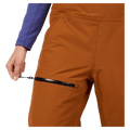 Leg pocket view of the Rossignol Outerlimits Insulated Bib in DEEP CARAMEL colourway, women model