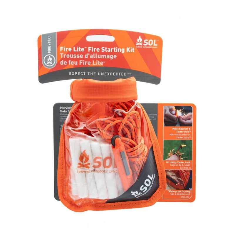 SOL Fire lite kit in cClear Dry Bag with orange trip and roll top. Showing contents inside of white cord, yellow safety cord and cardboard instructions