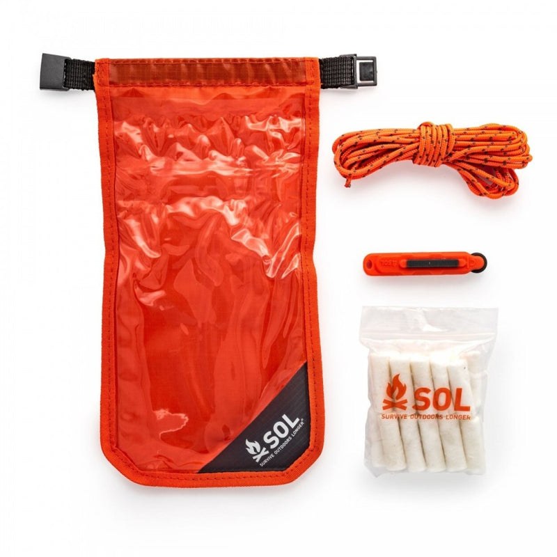 SOL Fire Lite Kit showing orange and clear dry bag, orange cord, white tinder quik and orange fire sparker.