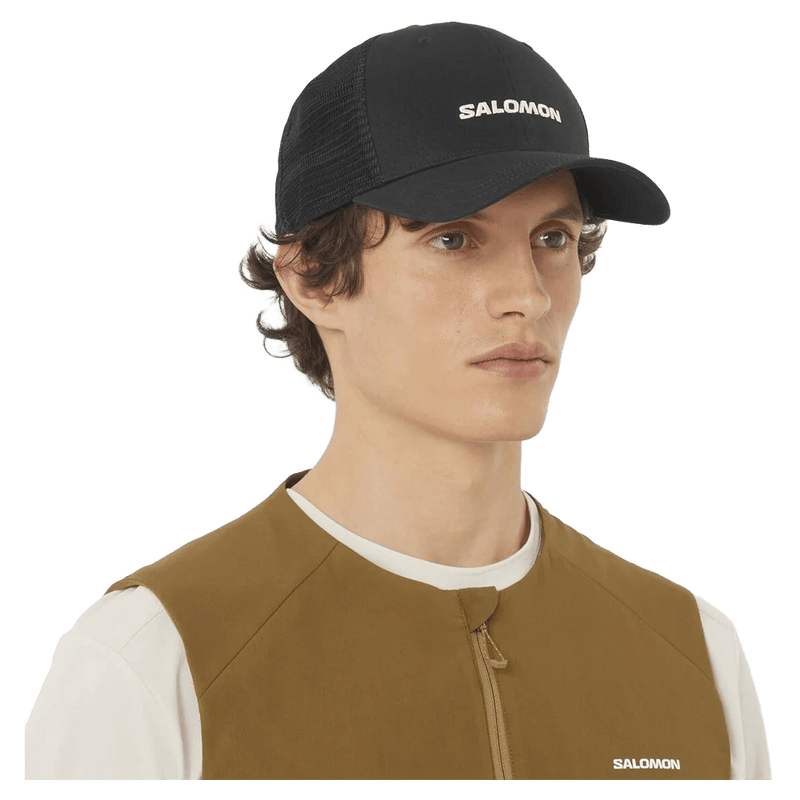 Worn view of the Salomon Trucker Cap in Deep Black colourway, unisex model