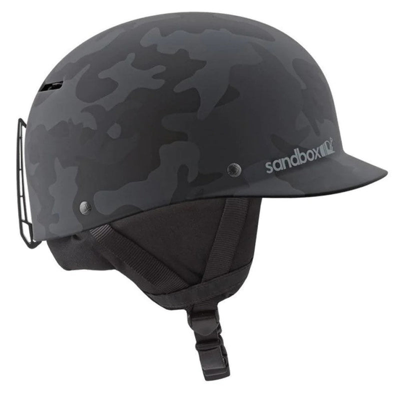 Main view of Sanbox Classic 1.0 Helmet in Matte Black Camo colour, featuring removable goggle clip and ear pads