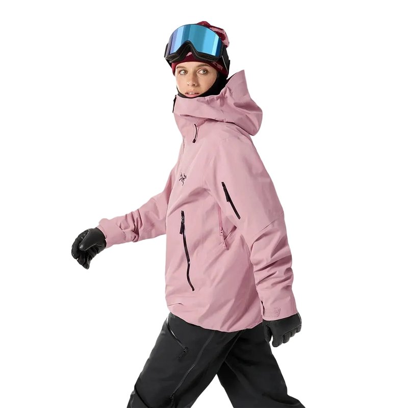 Side view of a woman wearing the Sentinel Ski Jacket in Bliss Black featuring a hood with adjustable toggle. 