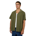 Man wearing Silent Theory's Conquor SS Shirt in olive colourway