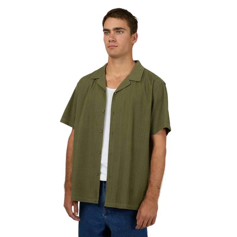 Man wearing Silent Theory's Conquor SS Shirt in olive colourway