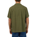 Back view of Man wearing Silent Theory's Conquor SS Shirt in olive colourway