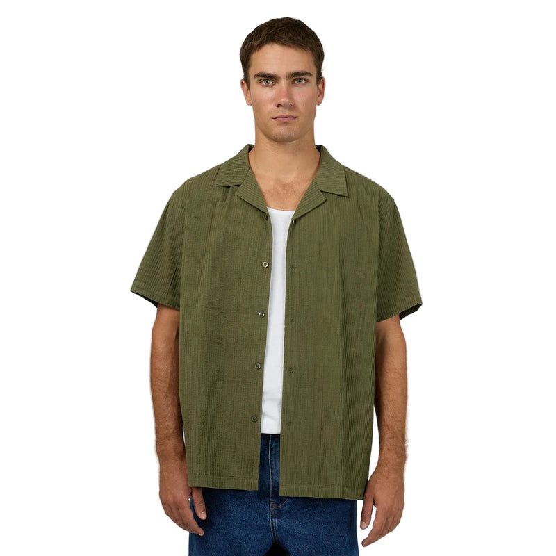 Front view of Man wearing Silent Theory's Conquor SS Shirt in olive colourway