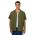 Front view of Man wearing Silent Theory's Conquor SS Shirt in olive colourway