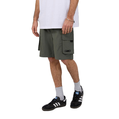 Man wearing Silent Theory's Cleaver Cargo Shorts in forest colourway