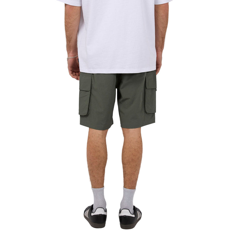 Back view of Man wearing Silent Theory's Cleaver Cargo Shorts in forest colourway
