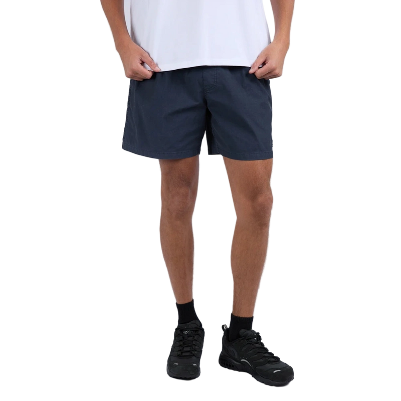 Man wearing Silent Theory Tres Shorts in navy colourway