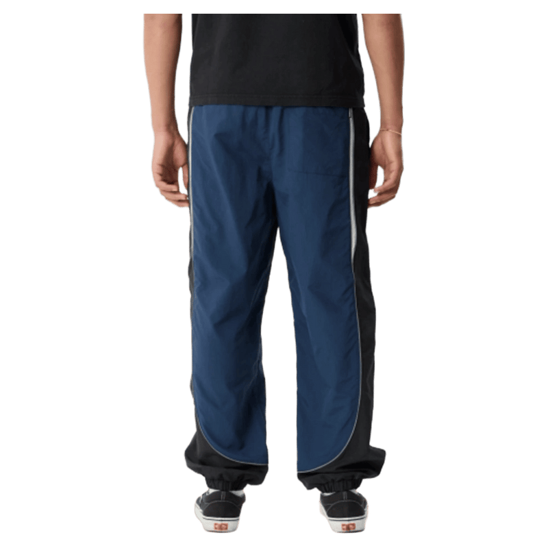 Back view of Afends Sporting Recycled Paneled Track Pants in colour Navy.