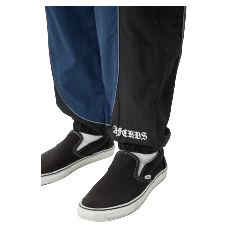 Bottom view of Afends Sporting Recycled Paneled Track Pants in colour Navy.