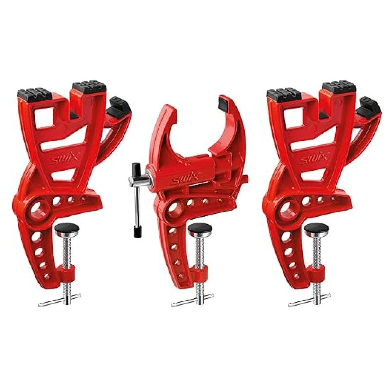 Red metal Swix alpine ski vises, 2 with hard rubber cushions, 1 with a jaw mecanism.