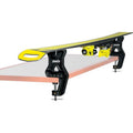 A pair of Swix Tuning vise in black ballistic plastic with silver metal screws vises on a table with a single ski laying on top