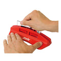 Model hands showing how to use the Swix Plexi Sharpener with a clear plastic scraper in the red plastic sharpener