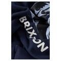 Close-up of navy blue Brixton hoodie fabric with white vertical branding and a light blue graphic print.