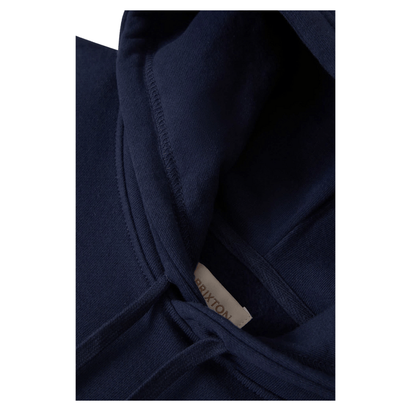 Close-up of a navy blue Brixton Two Boots Hoodie showing the hood, drawstrings, and interior brand tag.