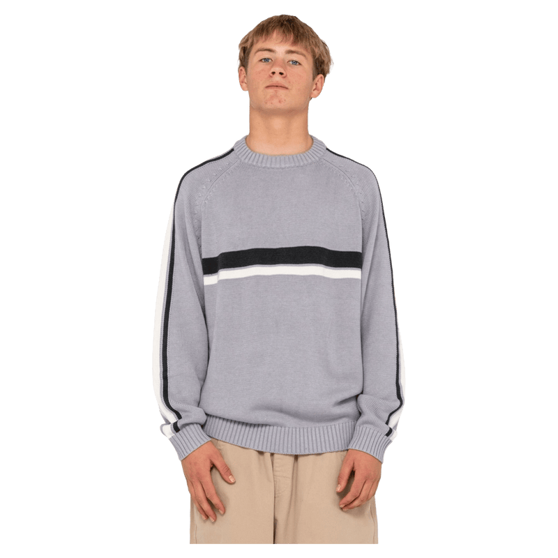 View of man in Rusty White Lines 2.0 Knitted Crew in colour Stone Grey