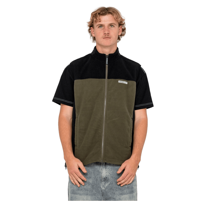 View of man in Rusty On The Run Tech Fleece Vest in colour Army Green