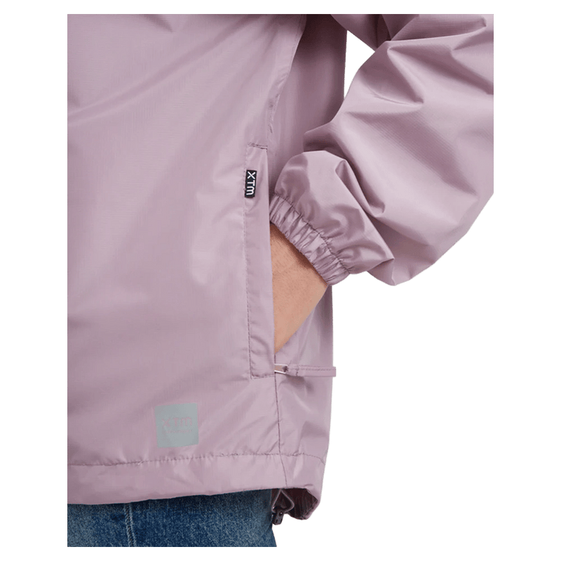 Pocket view of the XTM Stash 2L Rain Jacket in Fog colourway, unisex's model