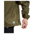 Pocket view of the XTM Stash 2L Rain Jacket in Kalamata colourway, unisex's model
