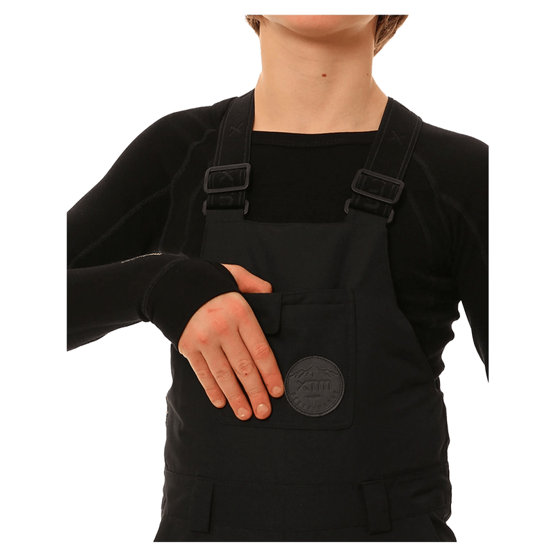 Detail view of the XTM Zeppelin Ski Pants in Black colourway, kids's model