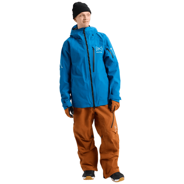 Blue Burton AK Cyclic Gore-Tex 2L Snowboard Jacket with black zippers and hood, worn by a model in brown pants.