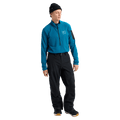 Man wearing black Burton AK Cyclic Gore-Tex 2L Snowboard Pants and a blue quarter-zip fleece.