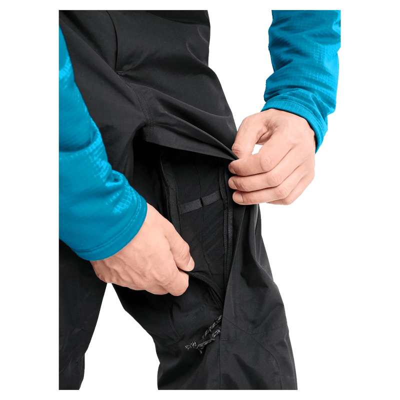 Close-up of black Burton AK Cyclic Gore-Tex pants showing a zippered thigh pocket with an internal mesh organizer.