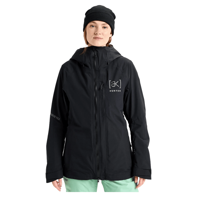 Black Burton AK Upshift Gore-Tex 2L women's snowboard jacket with hood and chest logo, front view.