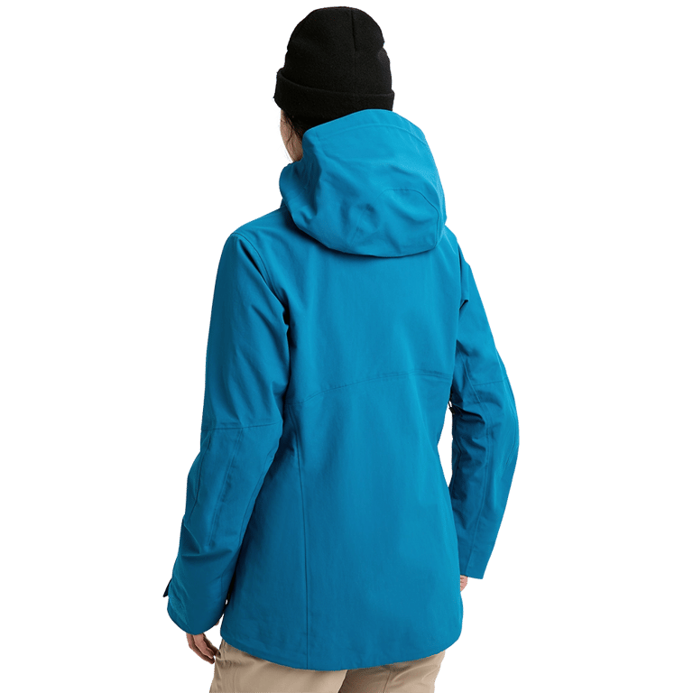 Rear view of a bright blue Burton AK Upshift Gore-Tex 2L women's snowboard jacket with a hood and black beanie.