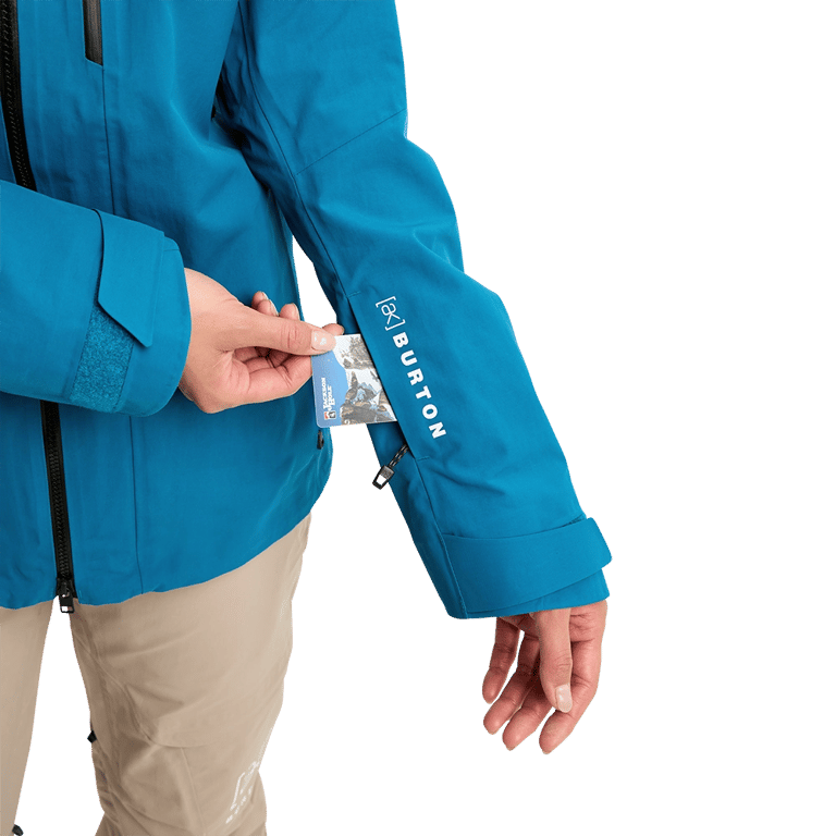 Blue Burton AK Upshift Gore-Tex jacket sleeve featuring a zippered pass pocket and white logo branding.