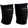 Pair of black Burton Basic Knee Pads with white logo, featuring contoured padding and slip-on stretch sleeves.