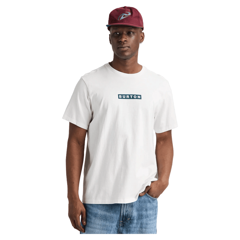 White Burton Dejaview short sleeve tee with a teal box logo on the chest, worn by a man in a maroon cap.