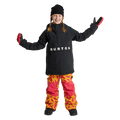Child wearing a black Burton Frostner Anorak jacket with white logo, black beanie, and patterned snowboard pants.