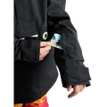 Black Burton Frostner Anorak kids jacket sleeve featuring a lift pass pocket with a card being inserted.