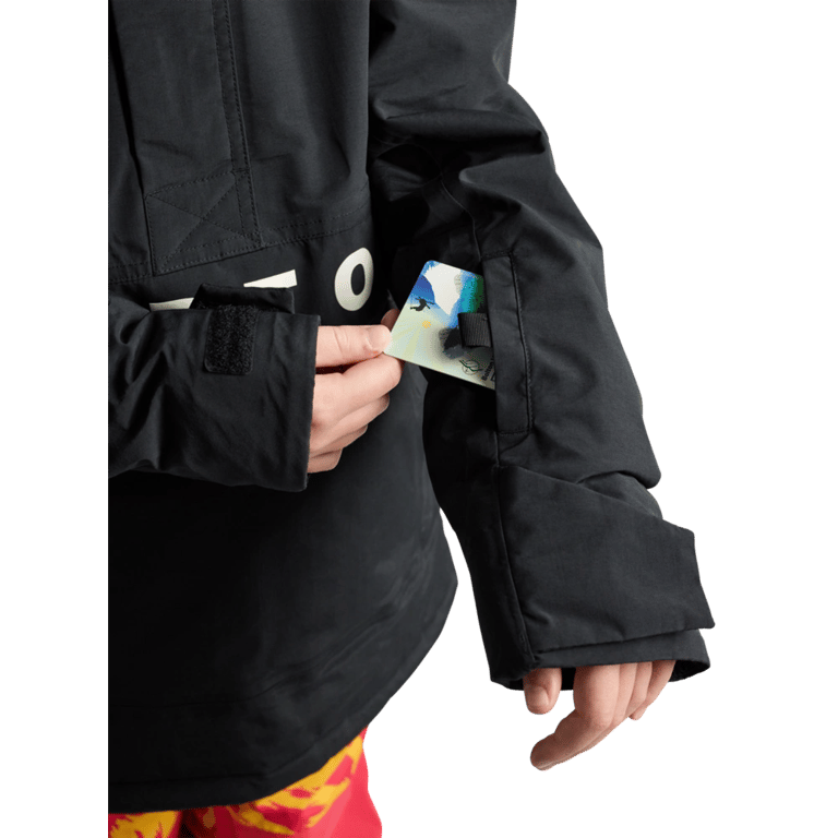 Black Burton Frostner Anorak kids jacket sleeve featuring a lift pass pocket with a card being inserted.