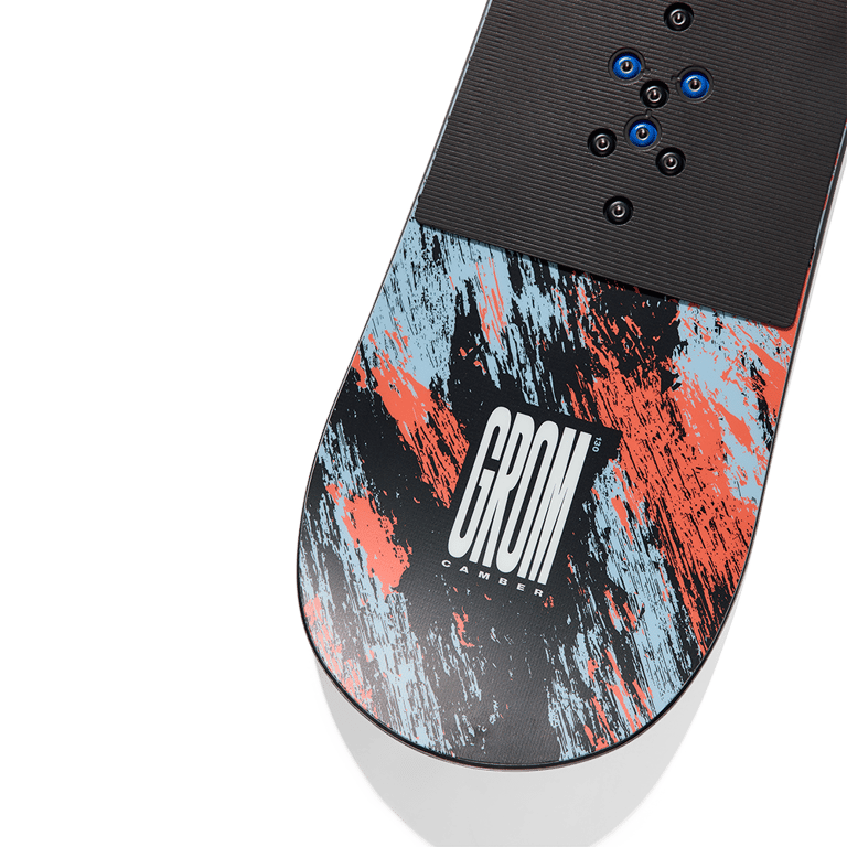 Burton Grom Camber kids snowboard featuring blue and orange distressed graphics and a black textured top sheet.