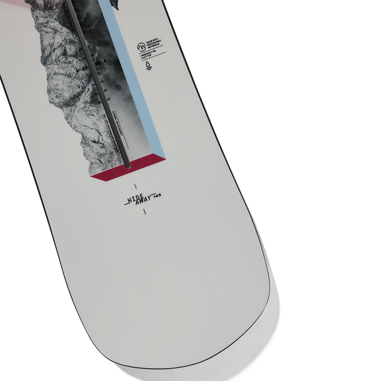 Close-up of white Burton Hideaway women's snowboard with mountain graphics and blue and red geometric accents.
