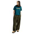 Teal Burton Ransacked short-sleeve t-shirt with chest graphic, worn with olive green wide-leg pants.