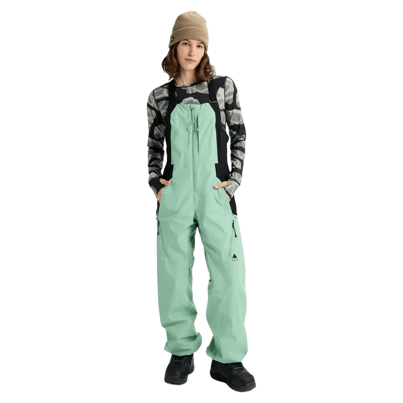 Mint green Burton Reserve Bib Snowboard Pants for women featuring adjustable straps and a chest pocket.