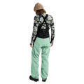 Rear view of women's mint green Burton Reserve Bib Snowboard Pants with black suspenders and a high back panel.