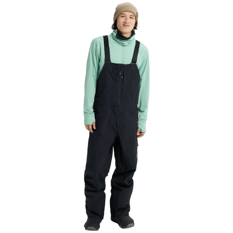 Black Burton Reserve Gore-Tex Bib Snowboard Pants with adjustable straps and chest pocket on a model.