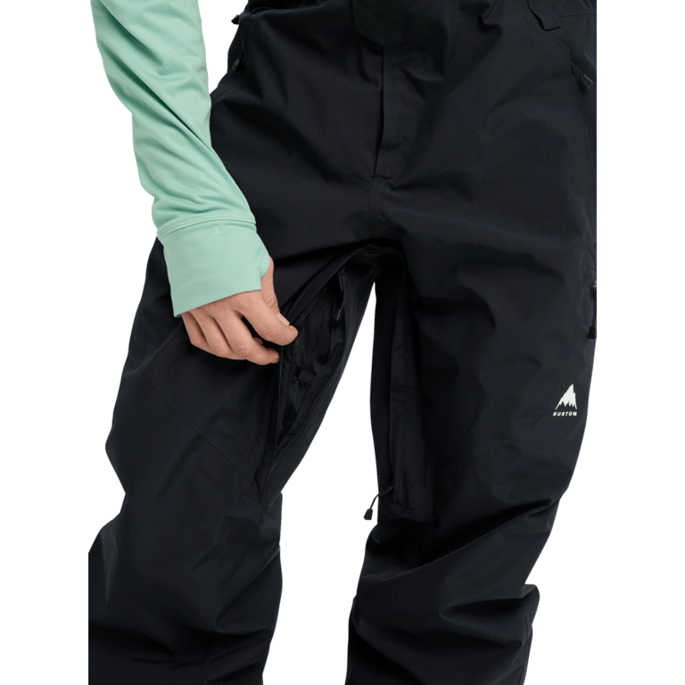 Black Burton Reserve Gore-Tex bib snowboard pants featuring a zippered inner thigh vent and white logo on the leg.