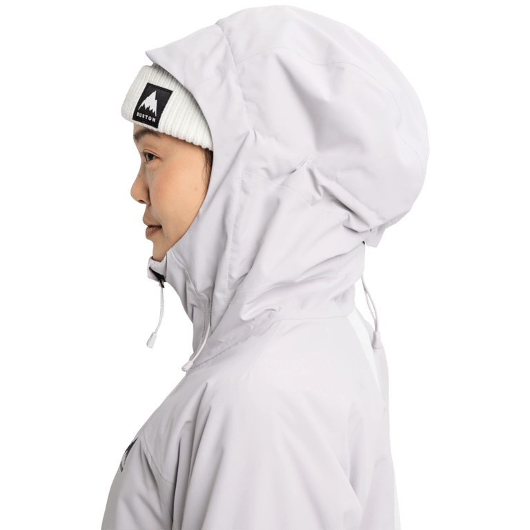 Side profile of a light grey Burton Reserve Insulated Snowboard Jacket with the hood up and a white beanie.