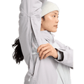 Woman opening the mesh-lined underarm vent on a light grey Burton Reserve Insulated Snowboard Jacket.