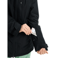 Black Burton Reserve Insulated Snowboard Jacket for women showing a lift pass being placed in a zippered sleeve pocket.