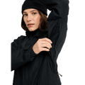 Woman in a black Burton Reserve Insulated Snowboard Jacket demonstrating the underarm ventilation zipper.