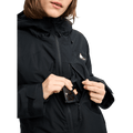 Black Burton Reserve Insulated Snowboard Jacket for women with a phone being placed in a zippered chest pocket.
